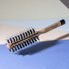 Hair Rituel round brush shapes bangs and short-to-medium hair for styling.