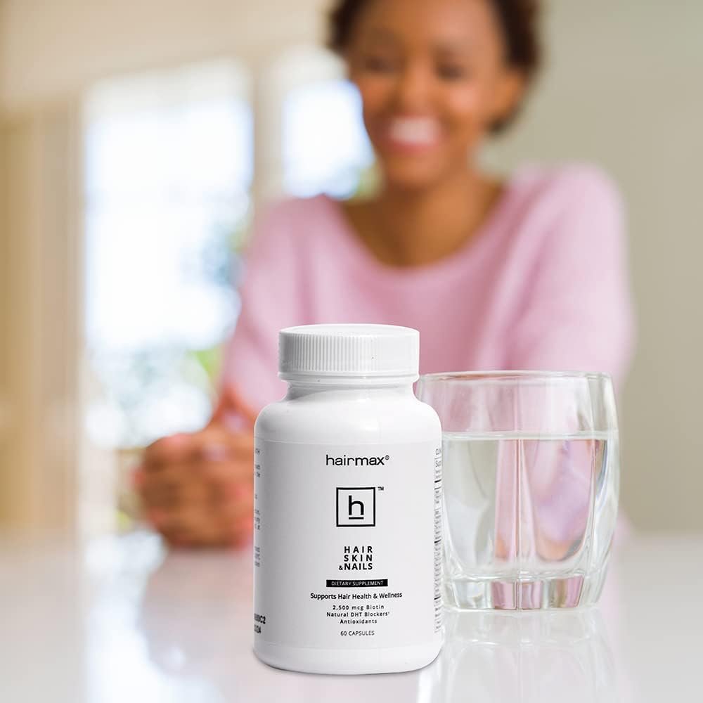 Hairmax bottle beside glass of water for simple regimen