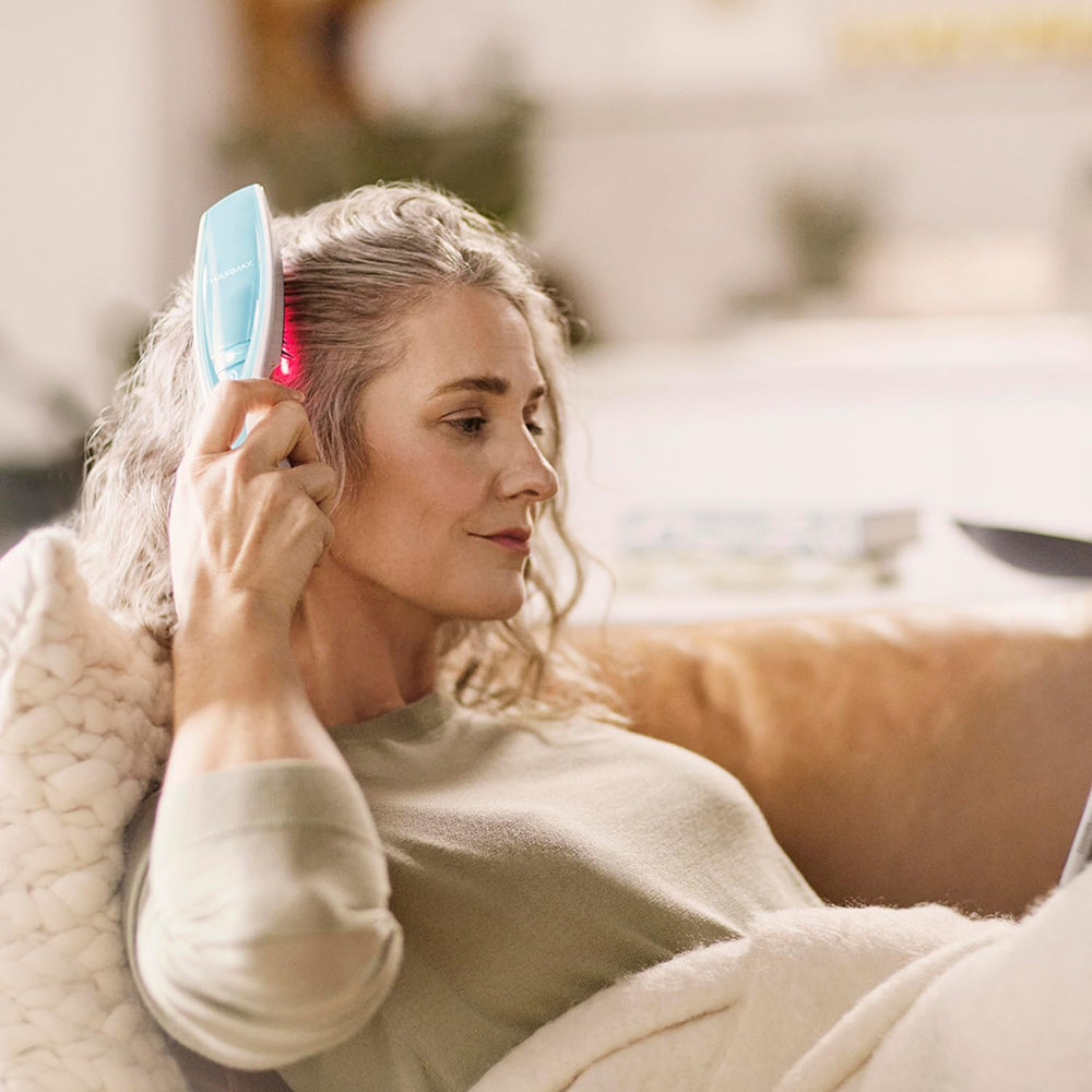 HairMax Ultima12 charging cradle shown for easy recharge and storage.