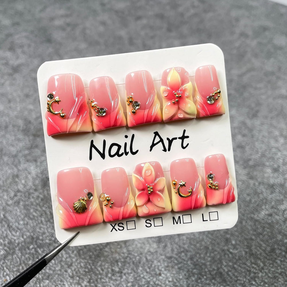 Handmade press-on nails with moon and shell designs for elegant home spa nails