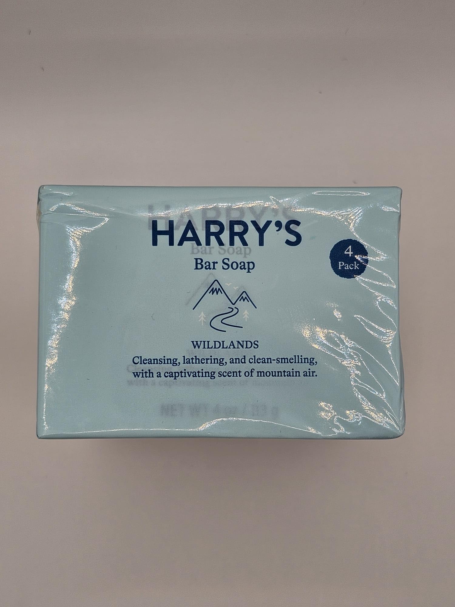 Open wrapper of Harry's Wildlands bar soap beside recyclable packaging.