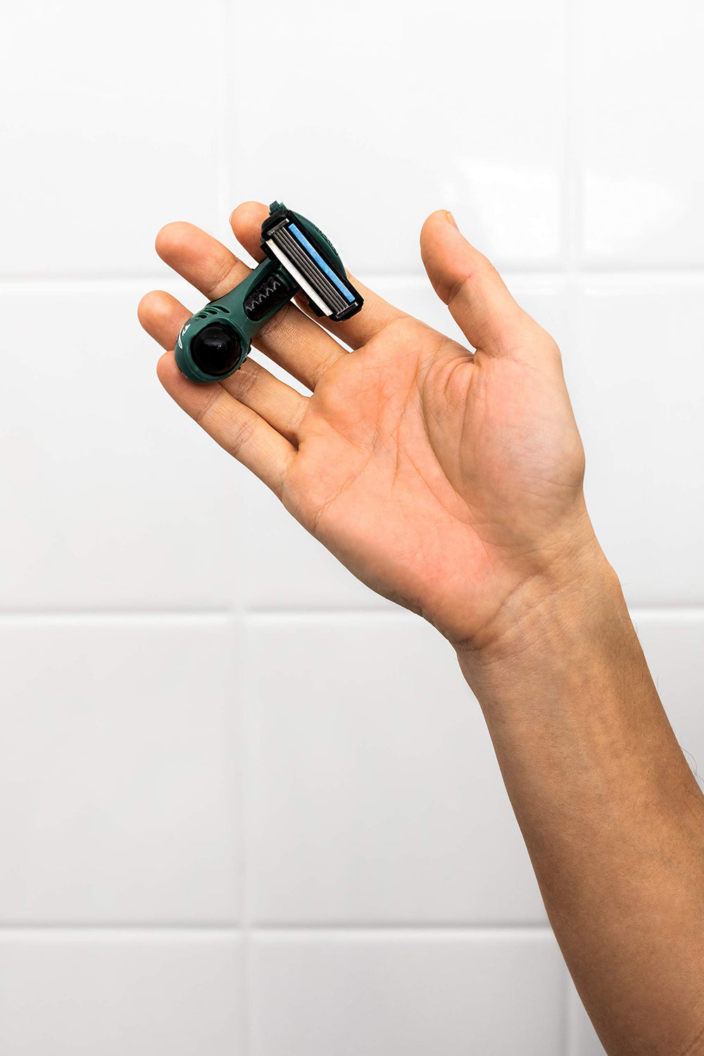 HeadBlade Moto LE Greene handle detail demonstrates ergonomic grip for control.