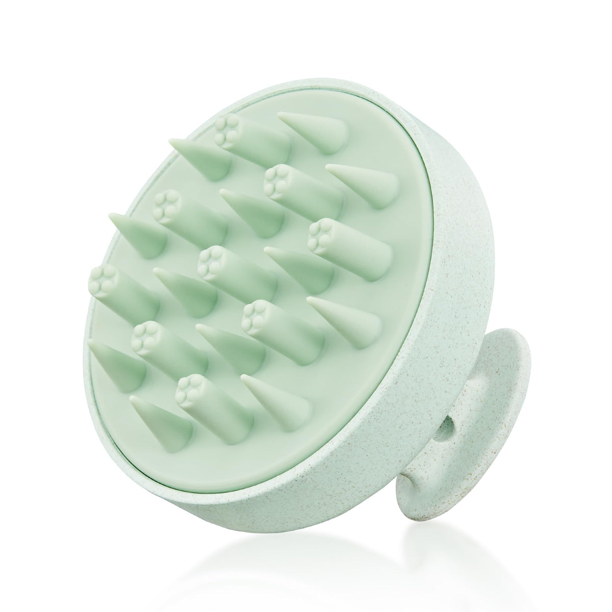 HEETA scalp massager in hand with eco-friendly wheat straw design and soft silicone bristles for gentle cleansing.
