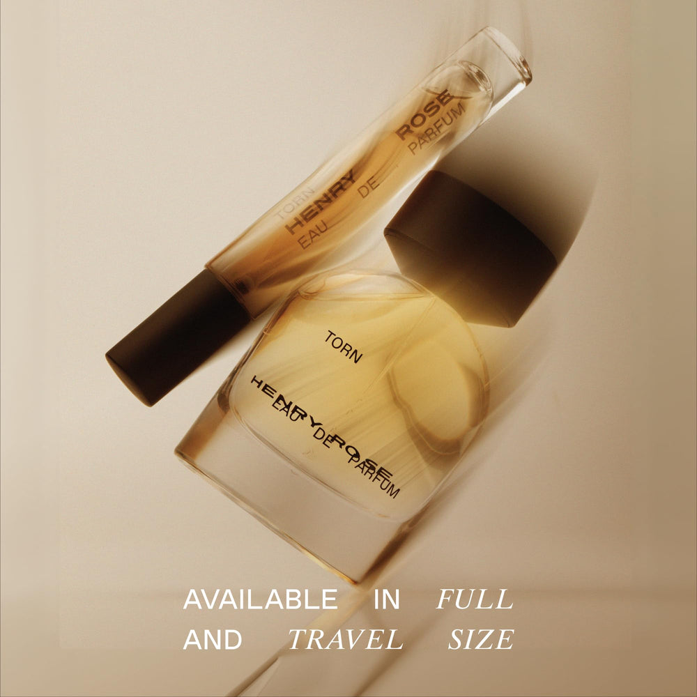 Torn ingredients list features freesia, jasmine, and vanilla bean.