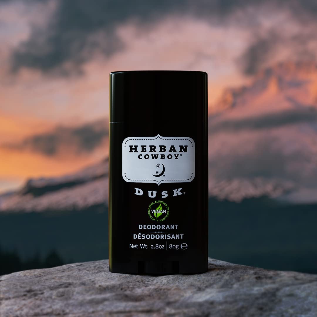 Herban Cowboy DUSK deodorant trio on bathroom shelf for daily freshness.