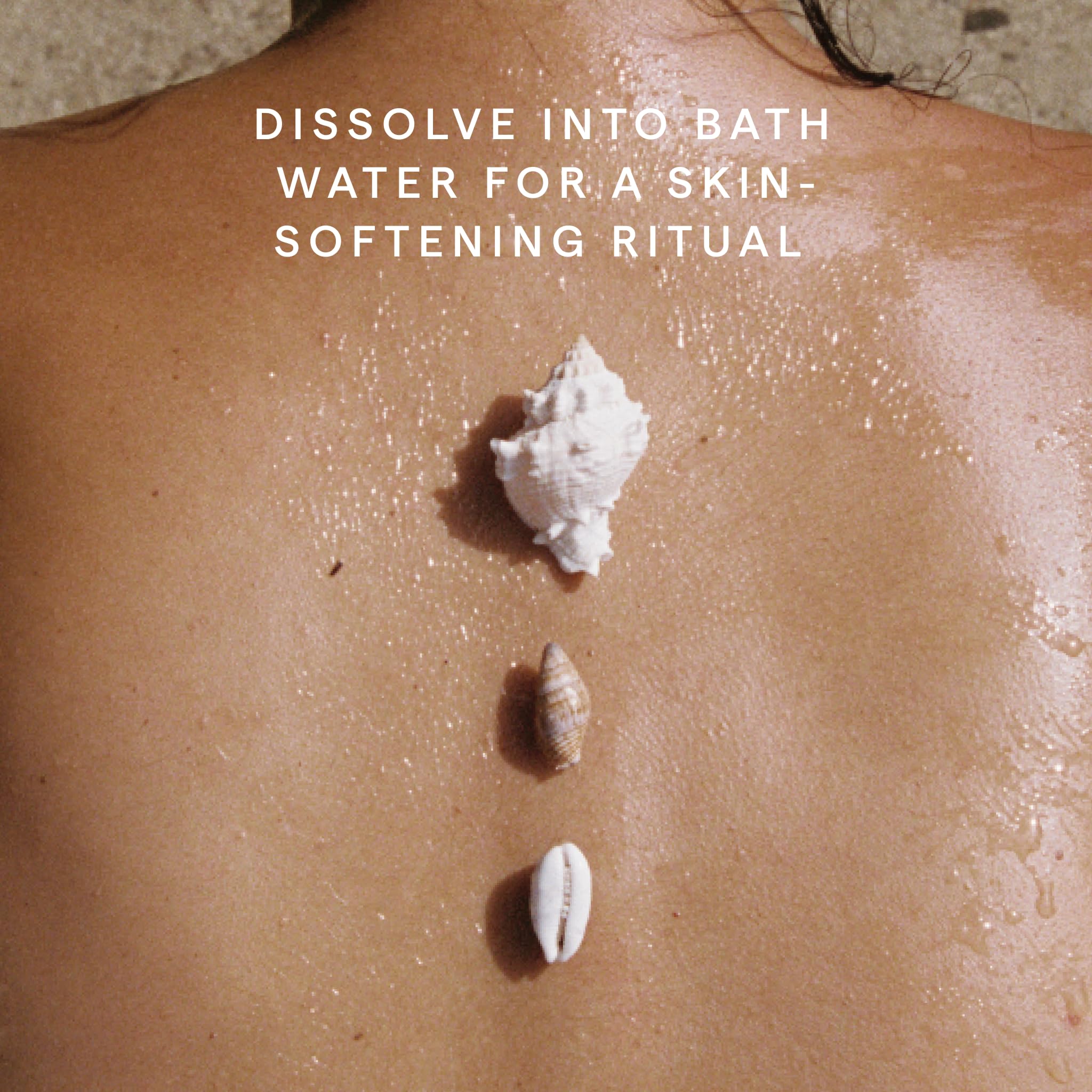 HERBIVORE Coconut Milk Bath Soak in a bath scene conveys hydrating escape.