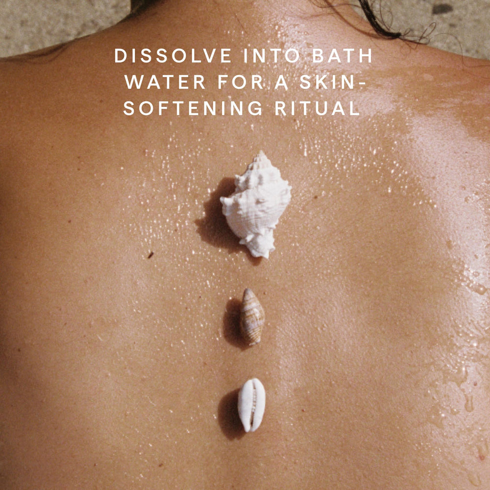 HERBIVORE Coconut Milk Bath Soak in a bath scene conveys hydrating escape.