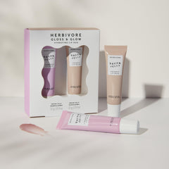 HERBIVORE Gloss and Glow lip duo close-up showcases dual balm sheen.