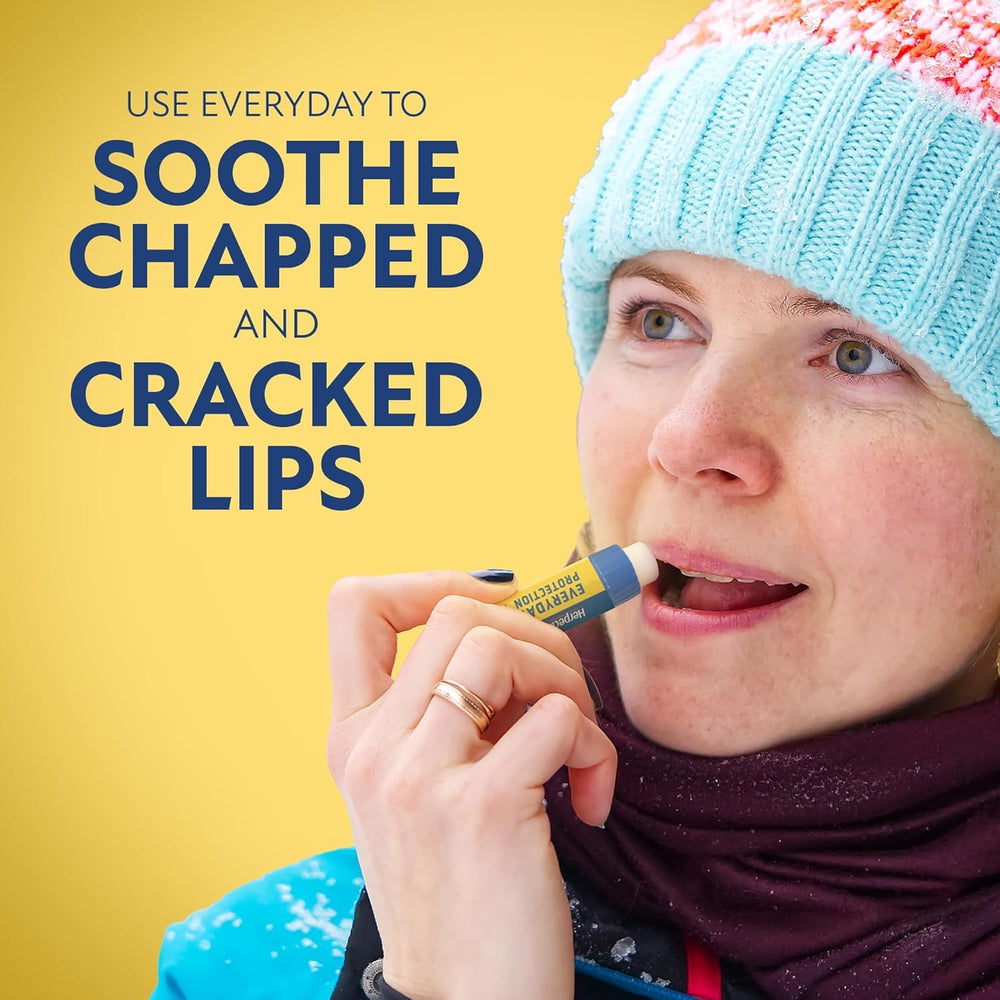 Closeup of Herpecin-L lip protectant SPF 30 tube shows smooth balm texture.