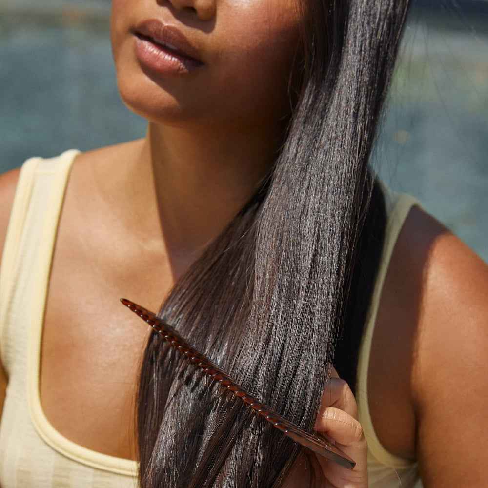 Hers Triple Threat bottle showing biotin and pumpkin seed oil for thicker-looking hair