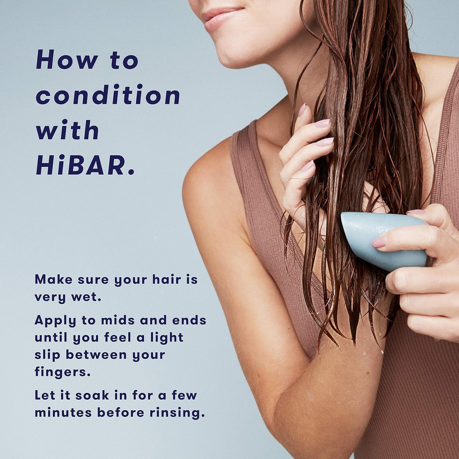 HIBAR Soothe conditioner bar resting on hair, showcasing easy application.