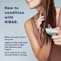 HIBAR Soothe conditioner bar resting on hair, showcasing easy application.