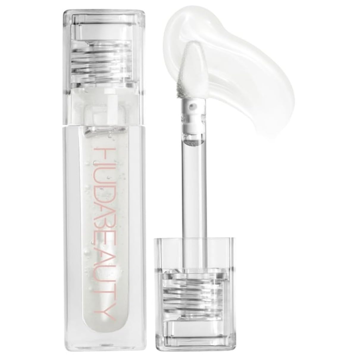 Huda Faux Filler Extra Shine Lip Gloss Glassy front bottle shows a clear, high-shine finish