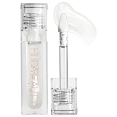 Huda Faux Filler Extra Shine Lip Gloss Glassy front bottle shows a clear, high-shine finish