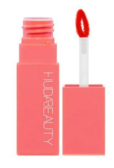 Huda Lip Blush Coral Kiss close-up; hydrating color for lips.