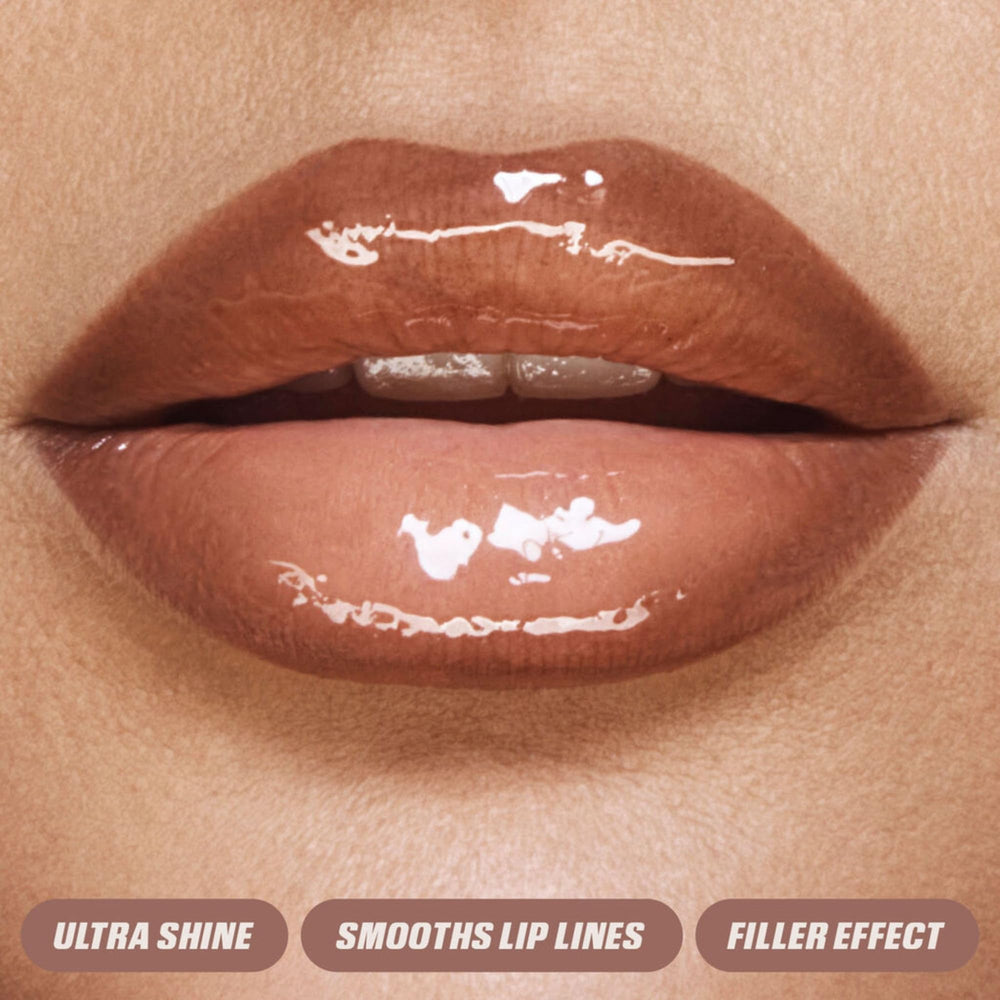 Huda Lip Gloss wand applying to lips for a glossy glow.