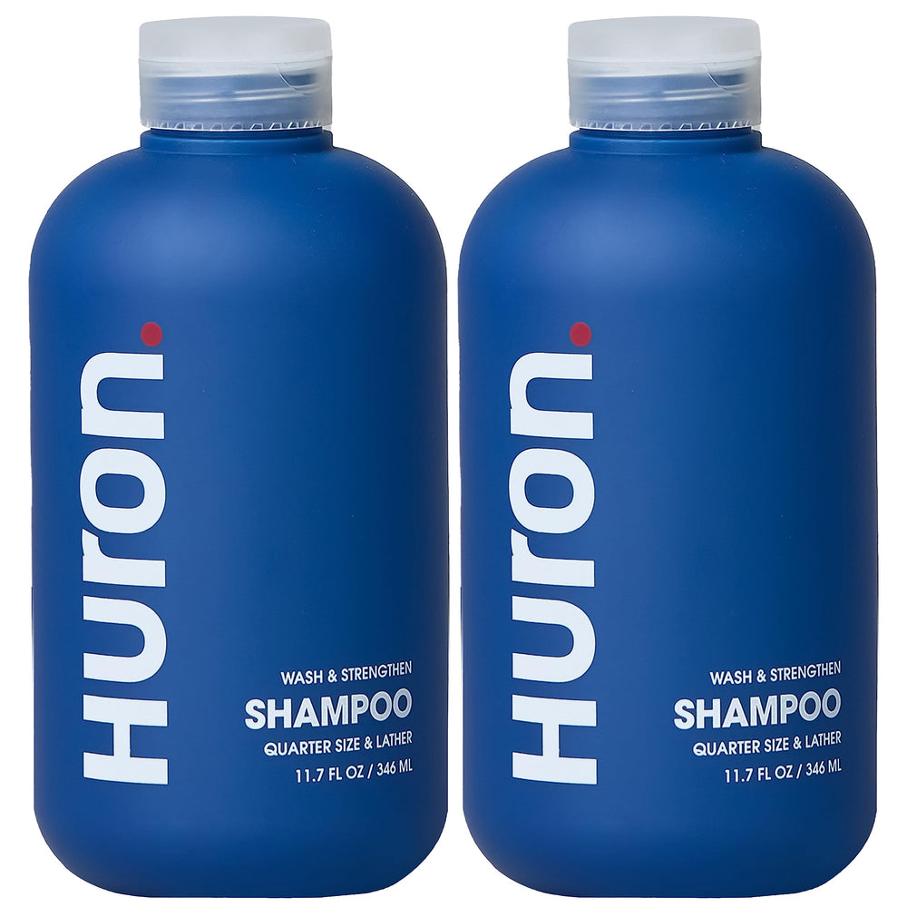 Huron Clean Citrus Woods shampoo bottle, 12 oz, sleek design for daily use.
