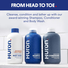 Huron Shower Kit conditioner bottle offering frizz control and shine