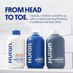 Huron Shower Kit conditioner bottle nourishes dry hair for smooth, manageable strands.