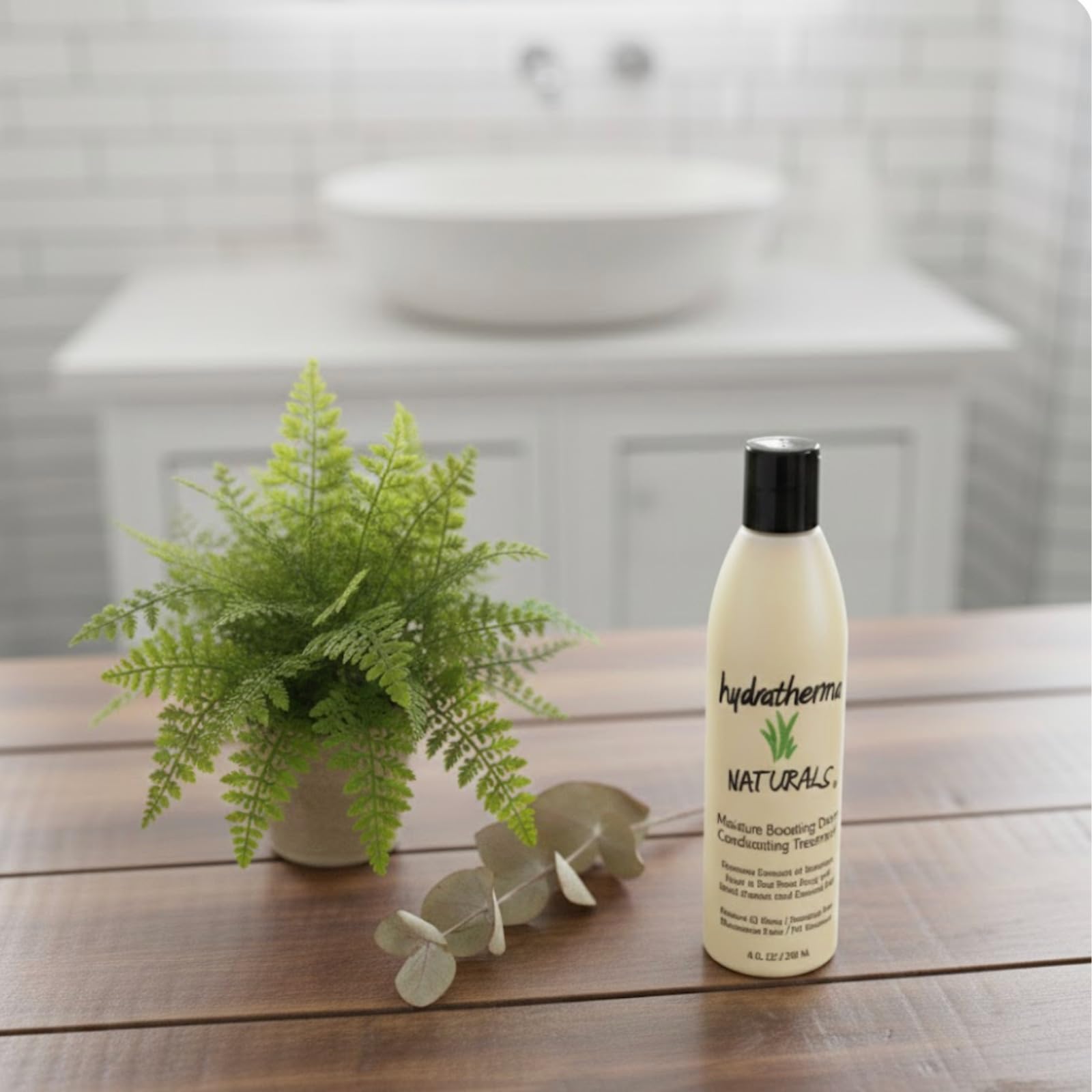 Hydratherma Naturals Moisture Boosting Deep Conditioning Treatment bottle on shelf evokes healthy glow.