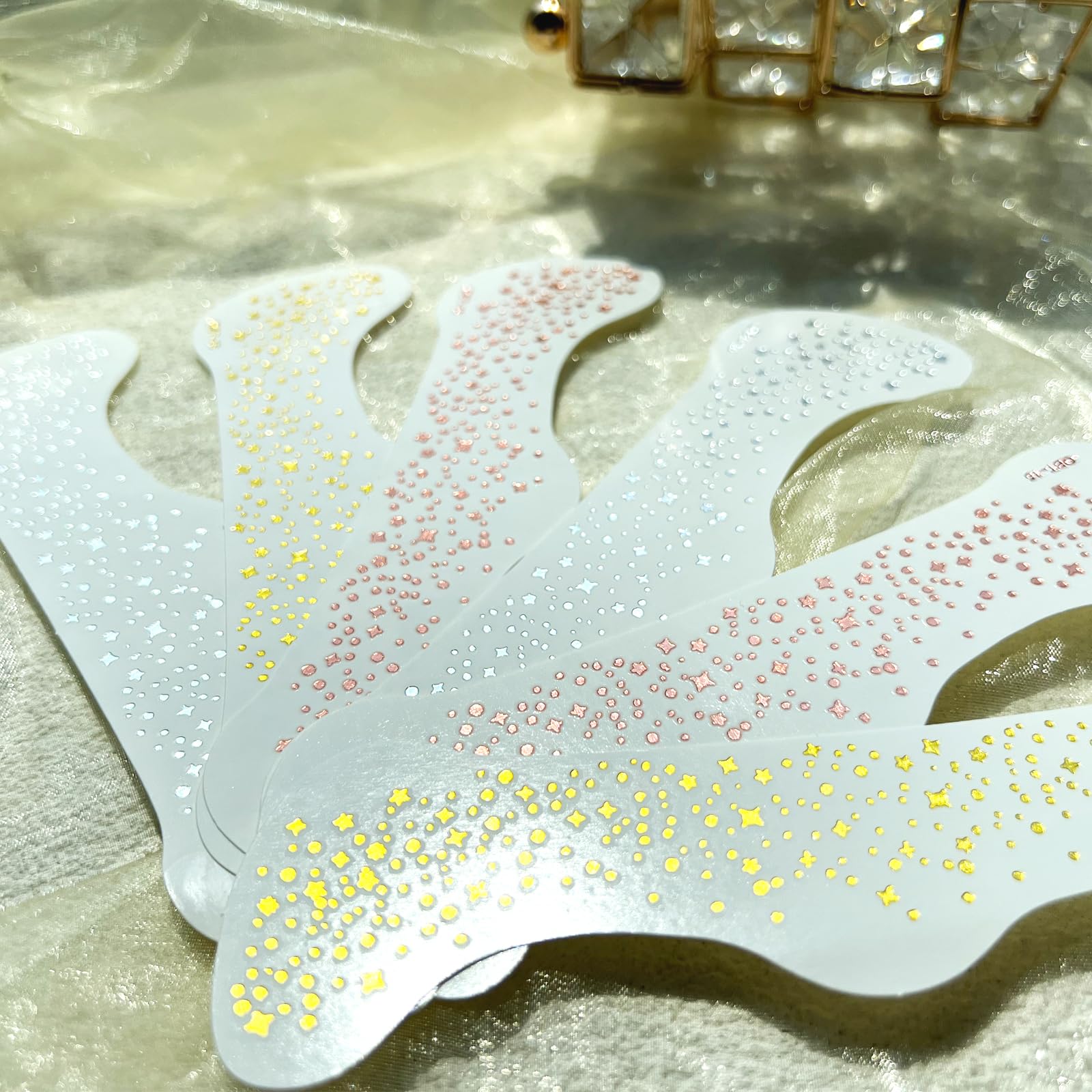 Hymik Mini gold glitter patches add tiny sparkles to daily or party makeup.