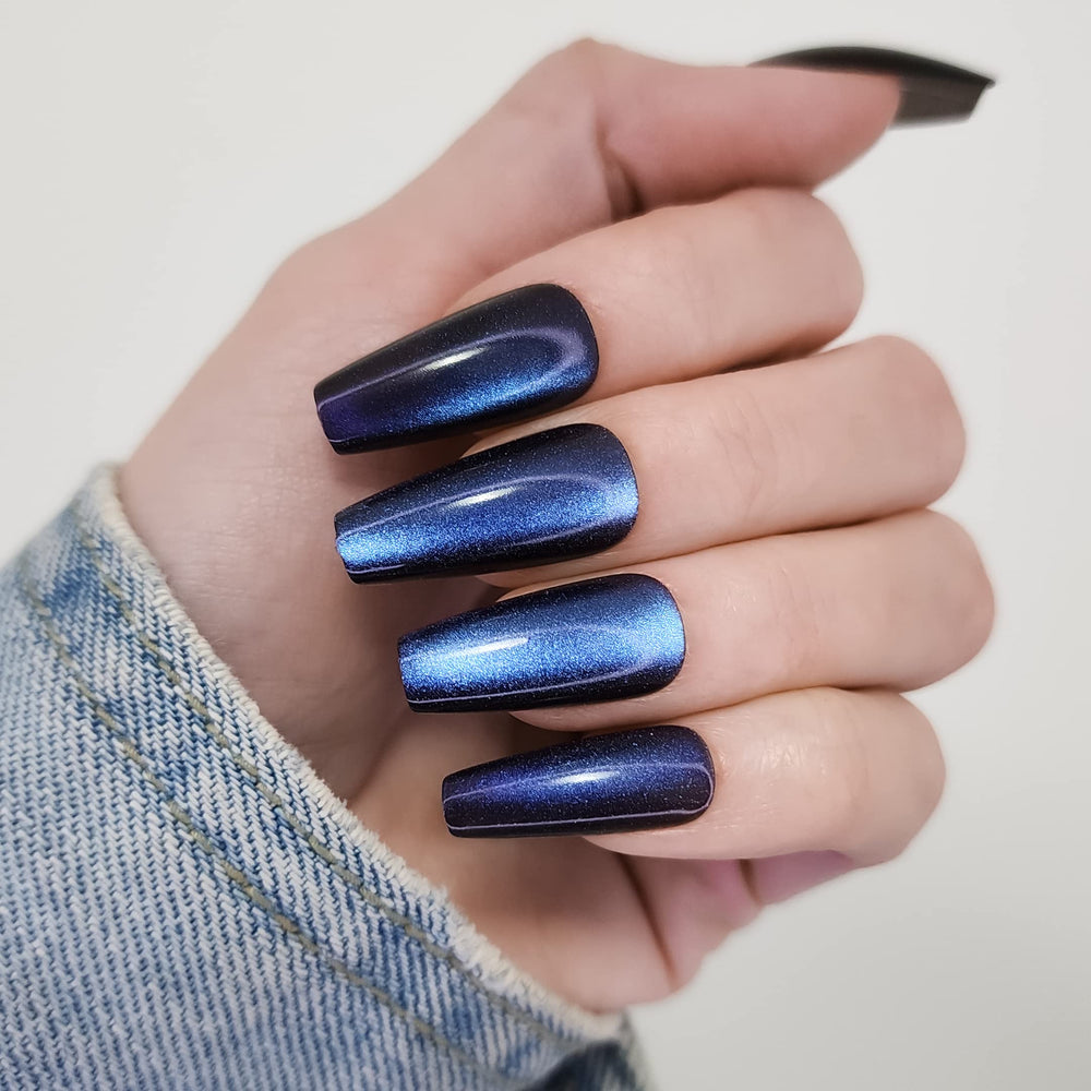 Hypnaughty Stardust Cat Eye coffin nails with blue-purple shimmer for at-home glam.