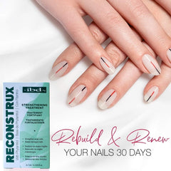 Close-up of the brush applying Reconstrux to nails for growth support.