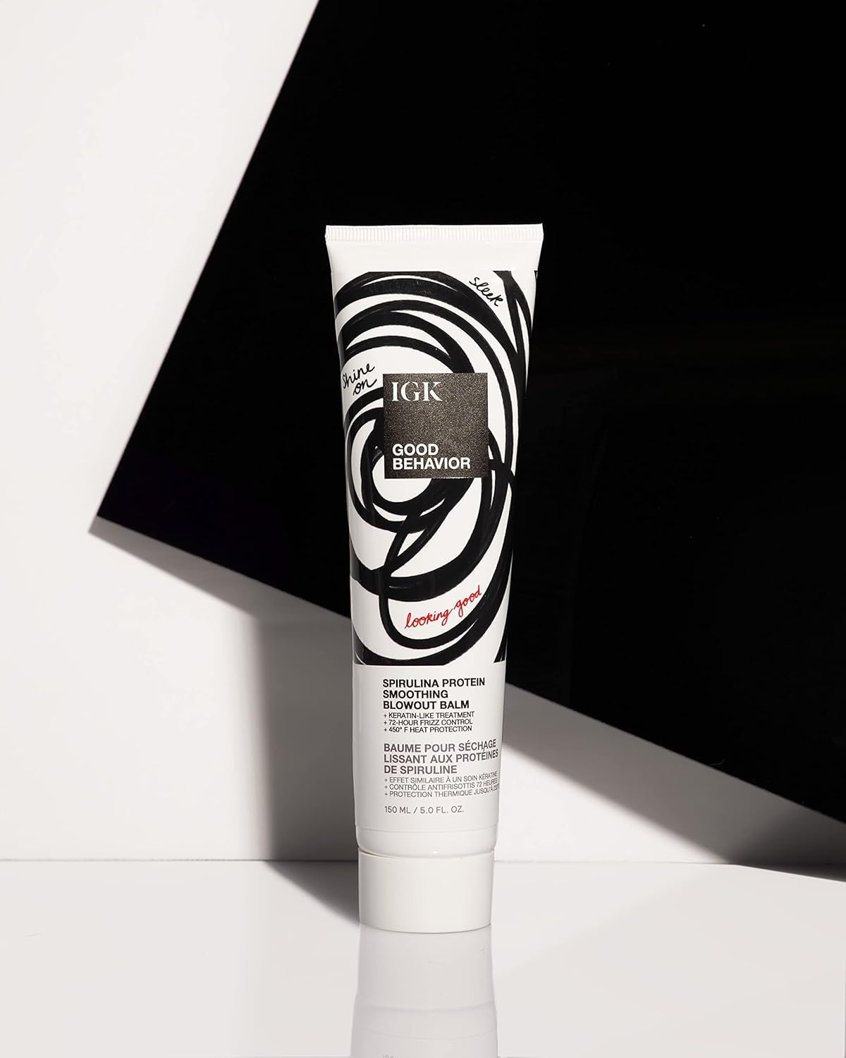 IGK GOOD BEHAVIOR smoothing spray application close-up for even coverage.