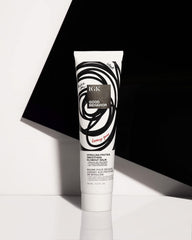 IGK GOOD BEHAVIOR smoothing spray application close-up for even coverage.