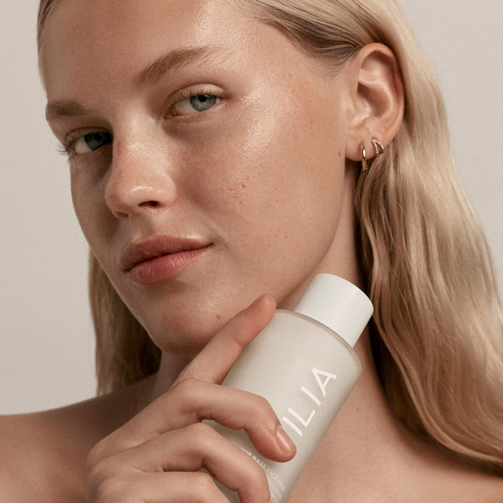 Texture closeup of ILIA Base Face Milk Essence shows satin-soft, layerable consistency.