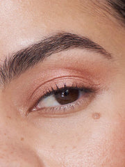 ILIA Chromatic Mythic swatch reveals rose-gold pearl glow on eyelid.