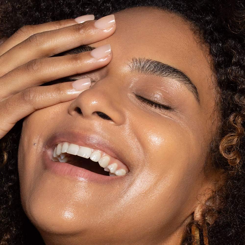 Shade swatch shows adaptable tone across diverse complexions.