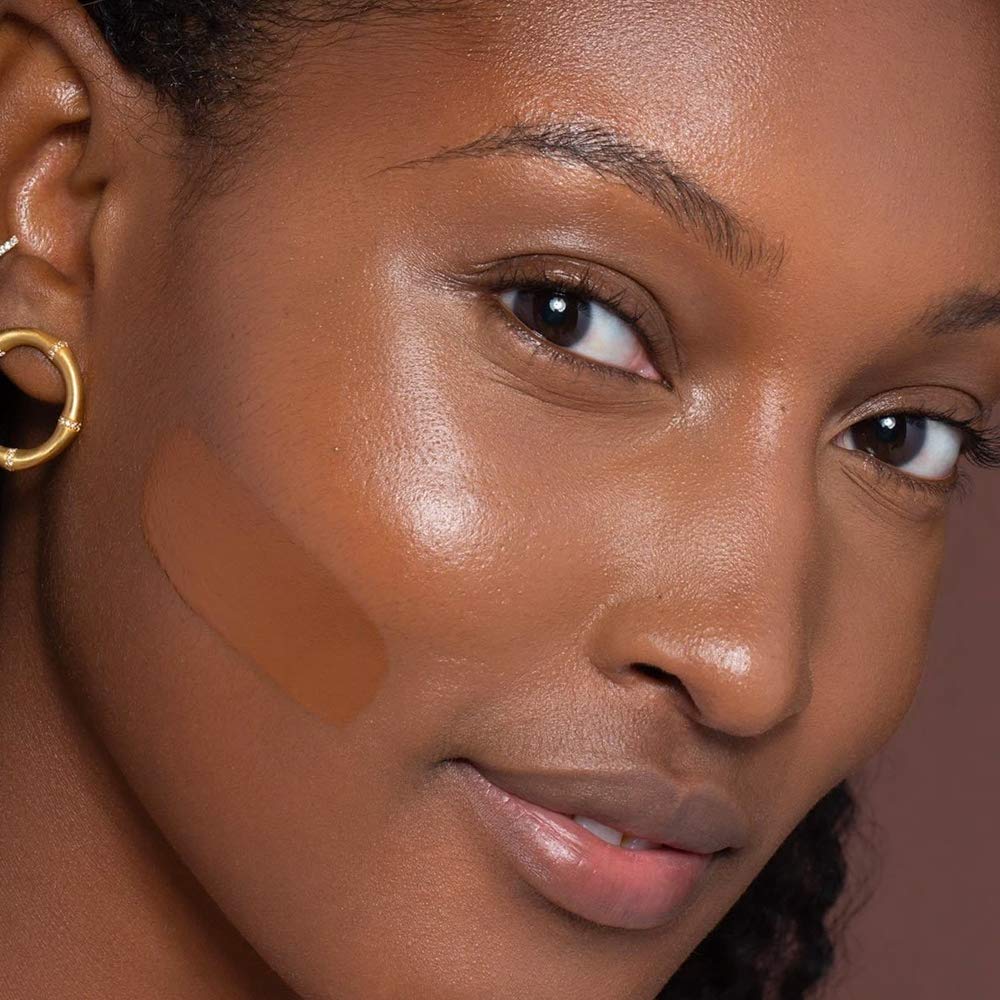 ILIA True Skin foundation applicator pump in use for smooth, even coverage.