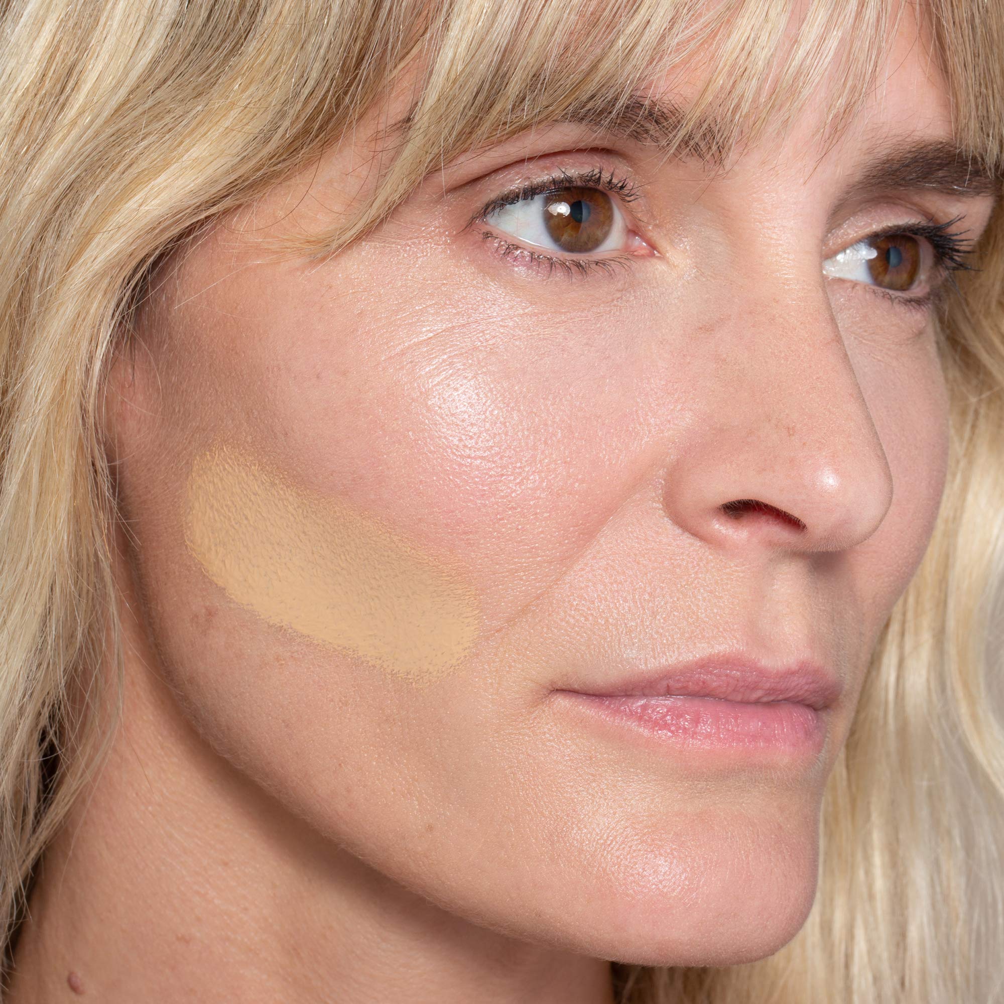 Close-up ILIA foundation swatch blended for skin-like result.