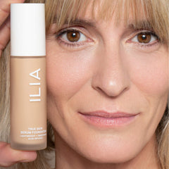 Silky texture of ILIA foundation being spread on skin.
