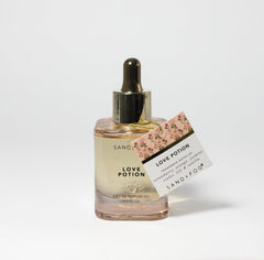 Sand + Fog Love Potion dropper in action showing precise application to pulse points