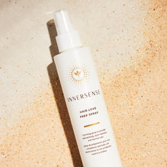 INNERSENSE Organic Hair Prep Spray mist being applied to hair for heat preparation.