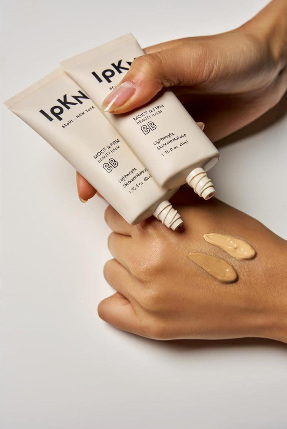 IPKN Moist and Firm BB Cream on skin with natural finish under varied lighting.