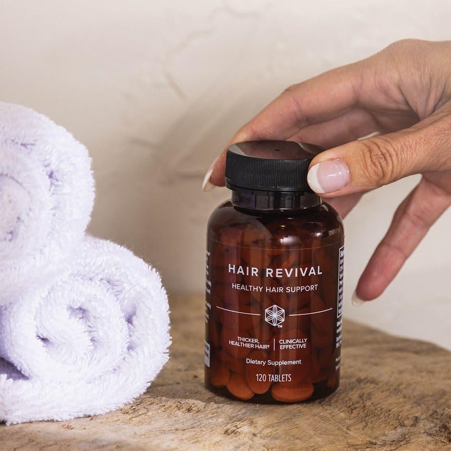 Isagenix Hair Revival daily-use setup with a glass of water for routine dosing.