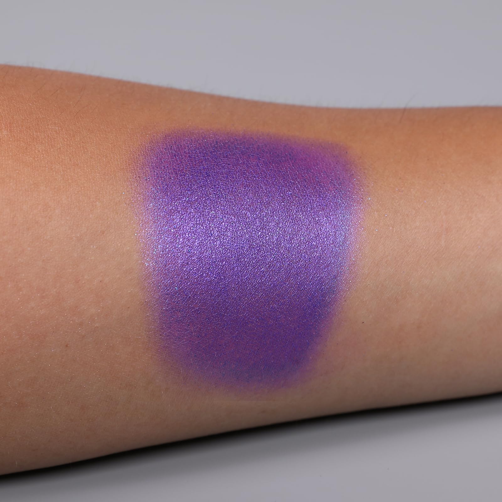 IS'MINE purple shimmer palette close-up pan highlights vibrant pigment depth.