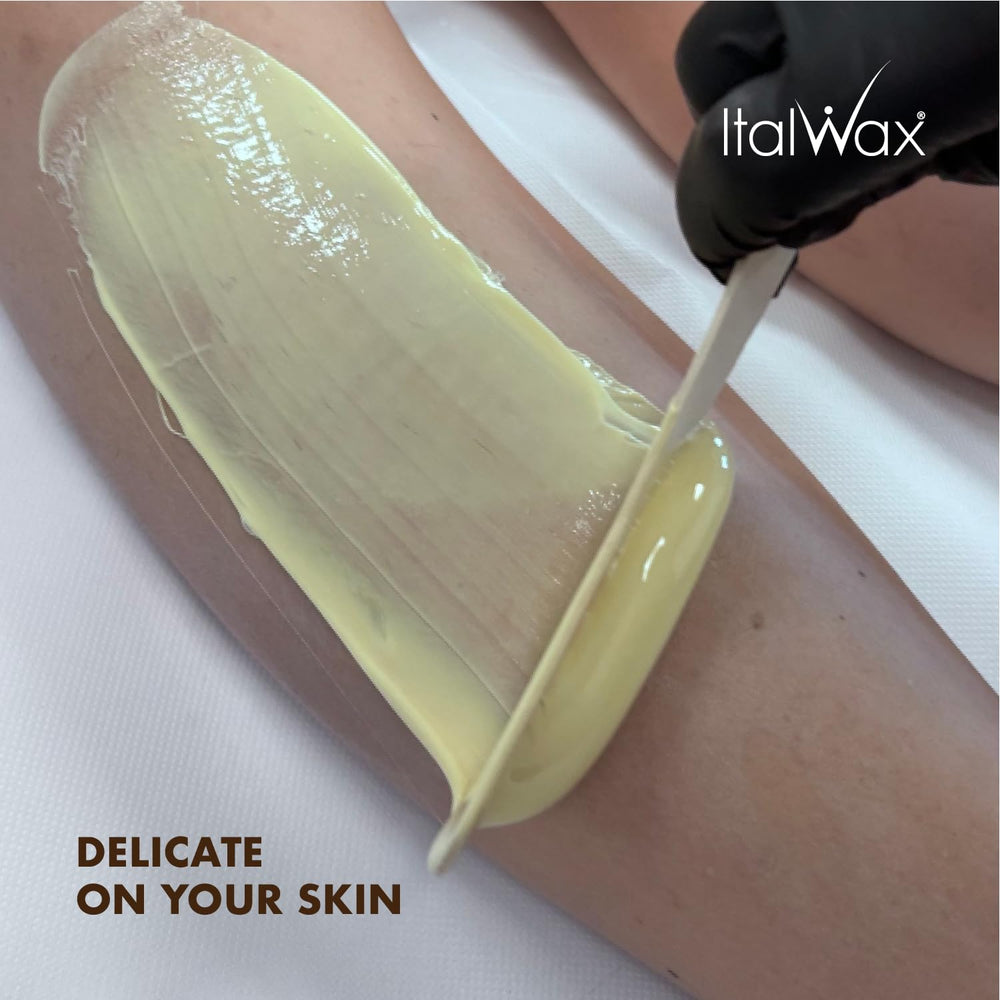 Professional esthetician using Italwax in spa setting.