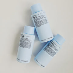 Close-up of J Beverly Hills Blue Everyday Moisturizing Conditioner texture coating damp hair.