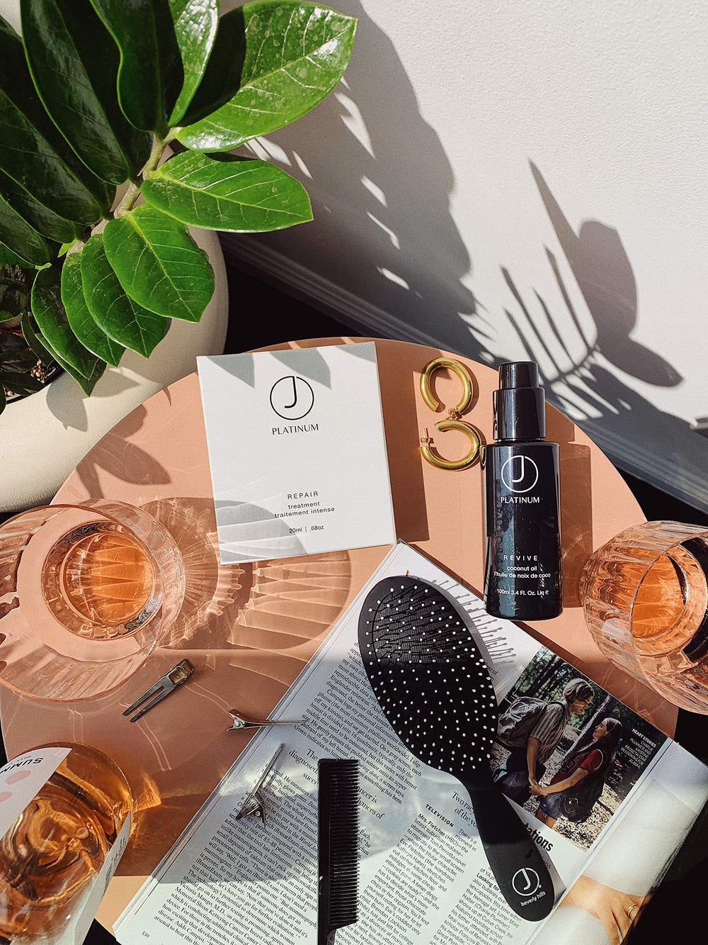 Hands emulsifying Platinum Revive oil before applying to mid-length hair