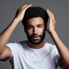 Styling hair with Jack Black Clay Pomade for texture and definition.