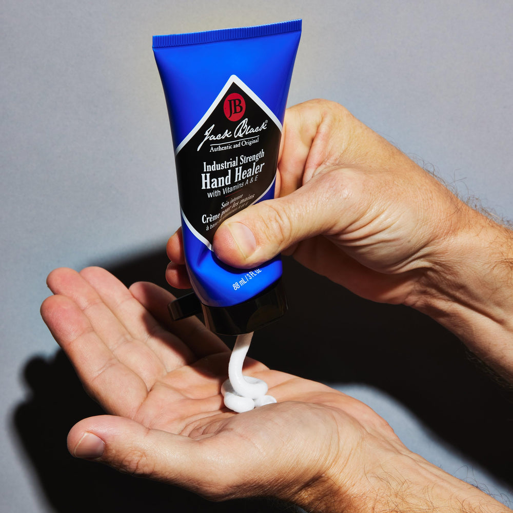 Jack Black Hand Healer jar beside tools highlighting durable protection for calloused skin