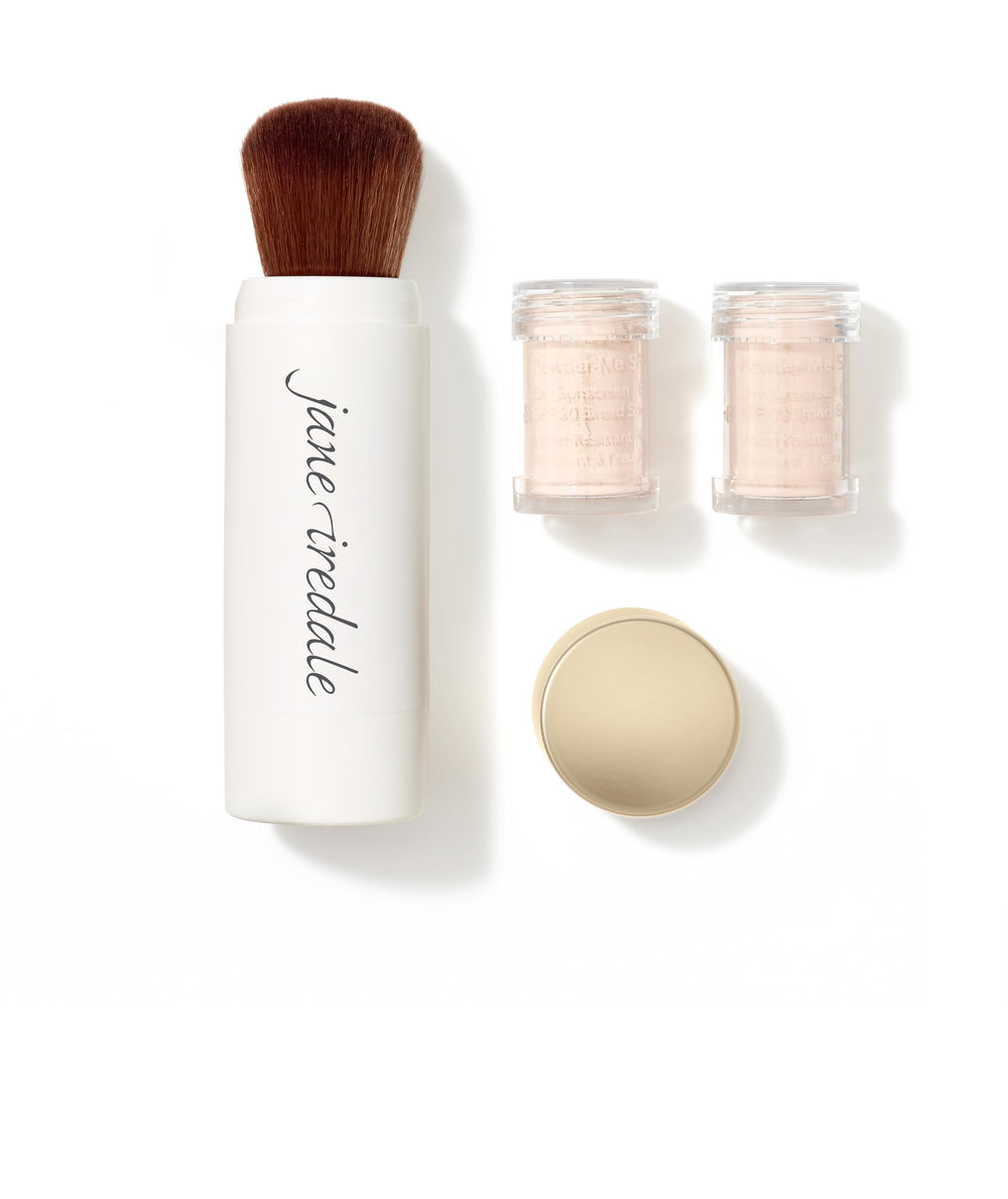 Jane Iredale Powder-Me SPF 30 brush applying lightweight sun protection to the face.