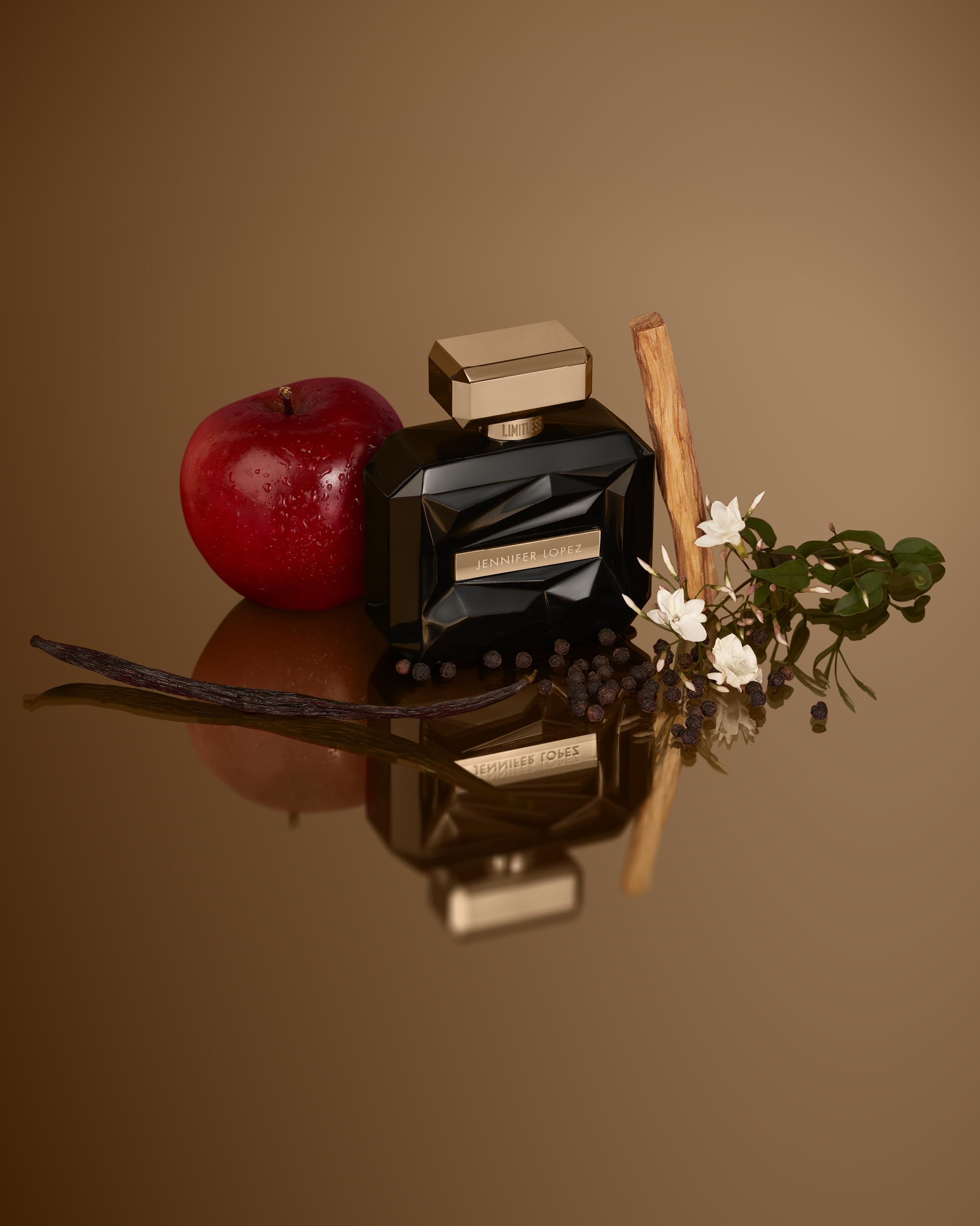 Jennifer Lopez Limitless perfume on reflective surface showing wood tones