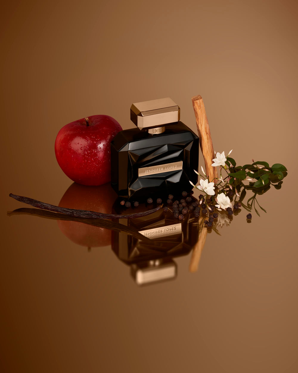 Jennifer Lopez Limitless perfume on reflective surface showing wood tones