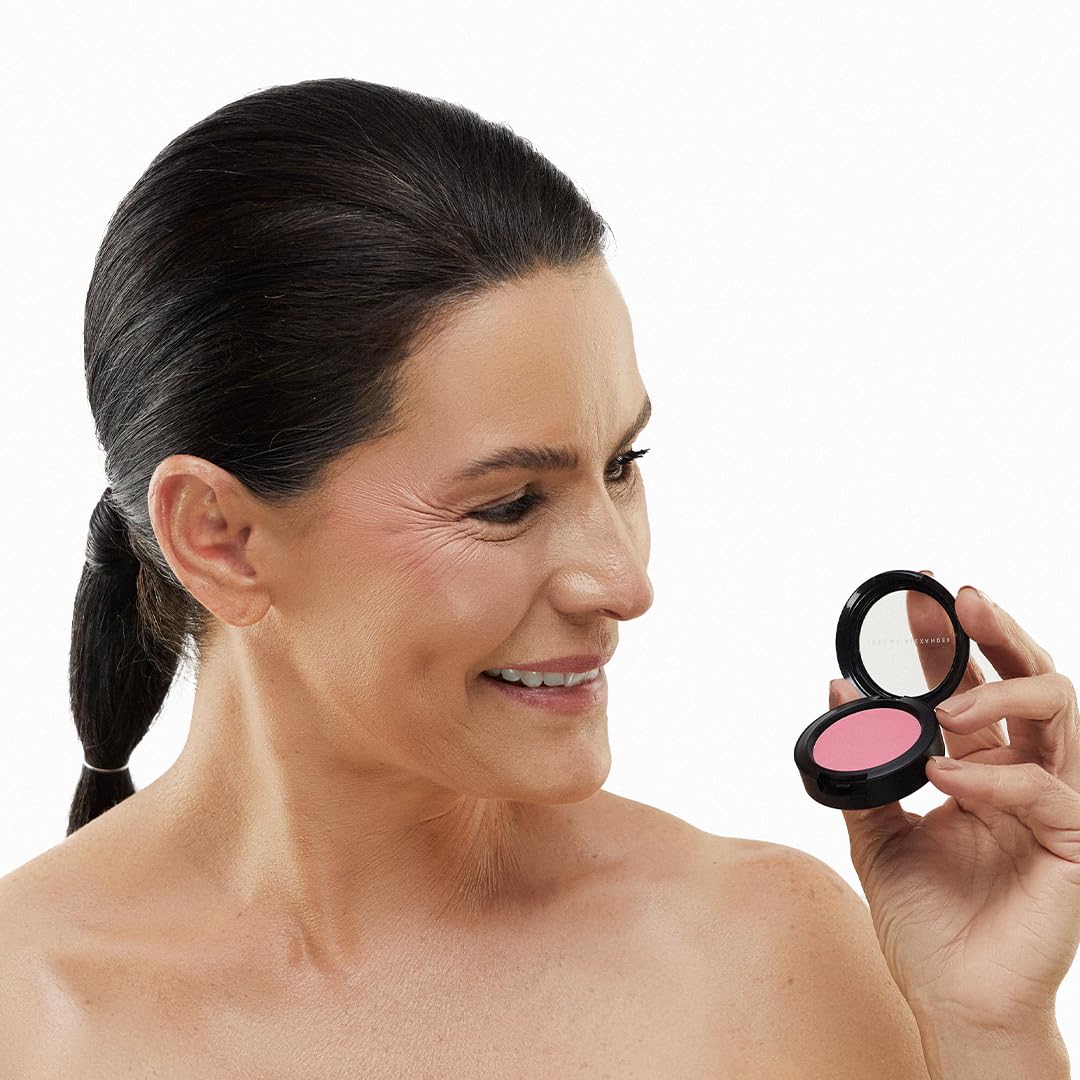 Jerome Alexander Blush ‘n’ Kiss Cream on lips with Watermelon tint for long-lasting color.