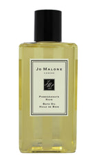 Jo Malone Pomegranate Noir Bath Oil bottle conveys luxury and long-lasting fragrance.